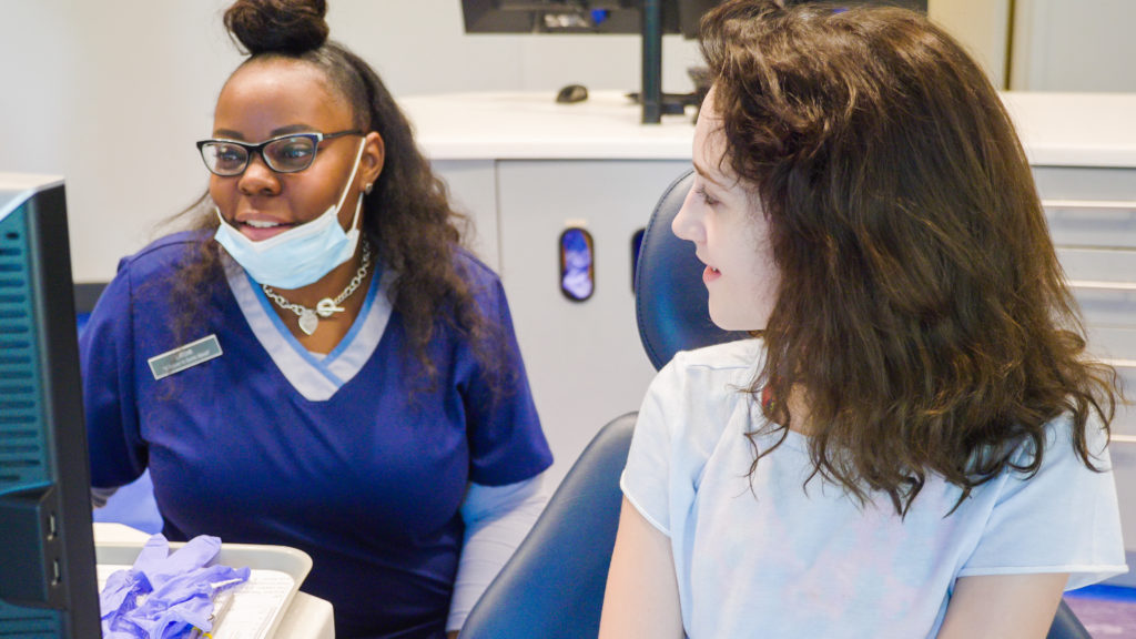 Frey Orthodontic staff working with a paitent