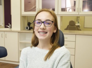 teen patient with braces and glasses