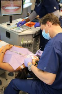 orthodontist working on a patient's mouth