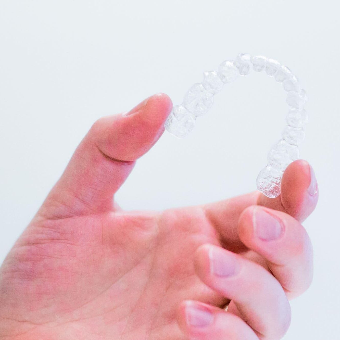 hand-holding-unbranded-aligners invisalign naperville il
